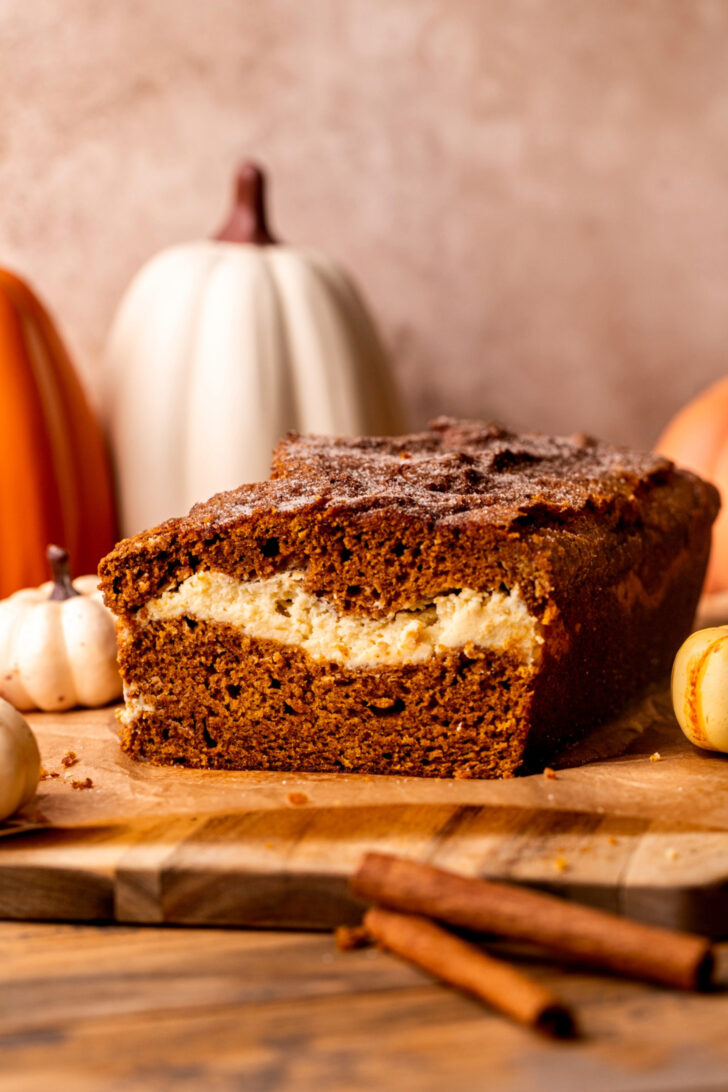 Pumpkin cream cheese bread on a wood board.
