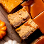 Two caramel pumpkin cheesecake bars on their side.