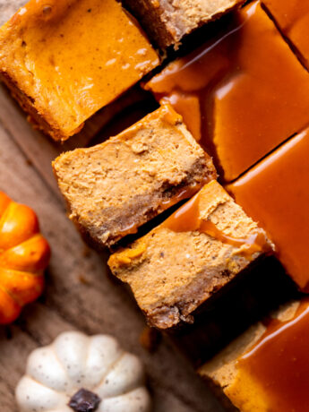 Two caramel pumpkin cheesecake bars on their side.