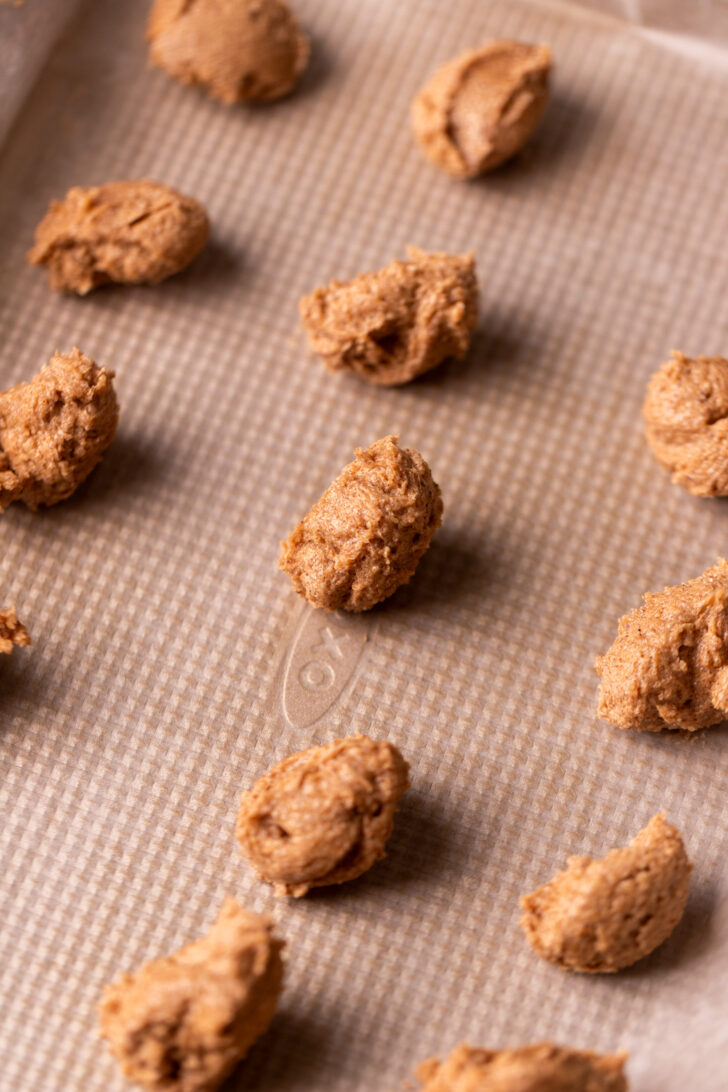 Cinnamon dollops on a cookie sheet.