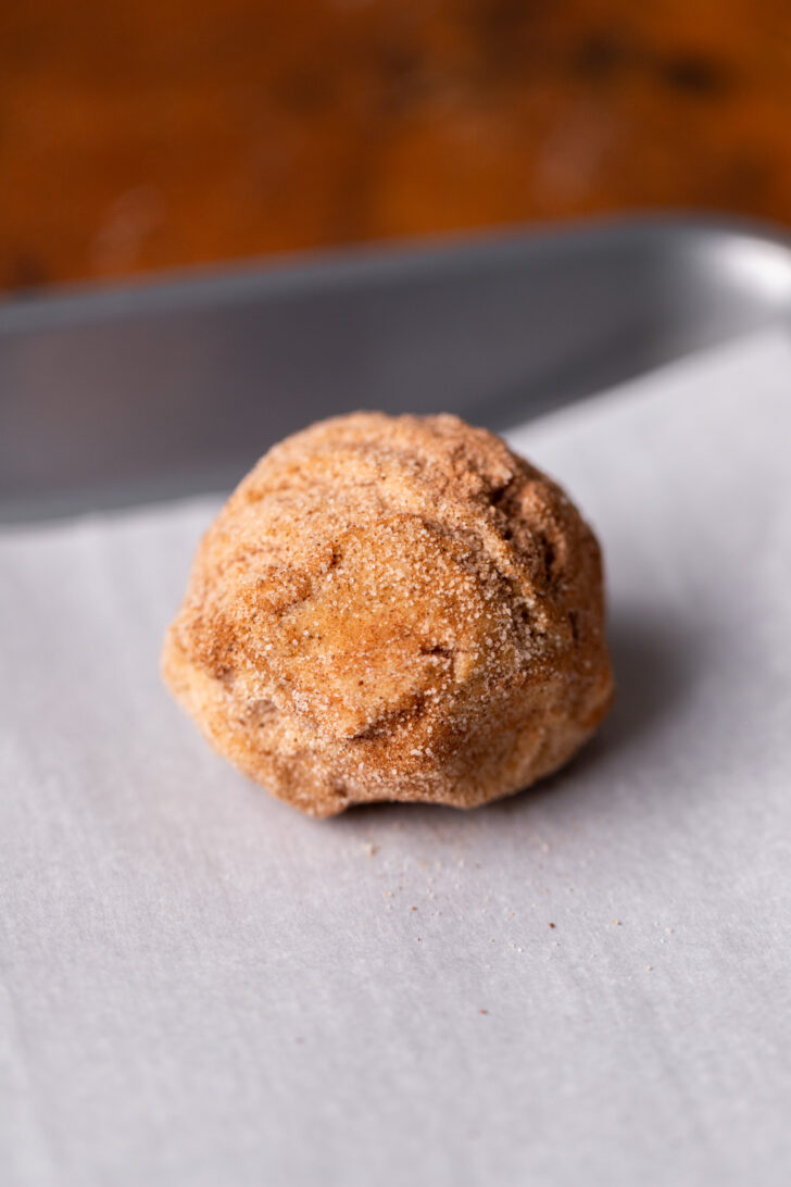 Cookie dough ball on a cookie sheet.