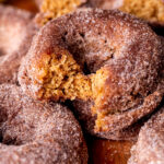 Bite missing from apple cider donuts.
