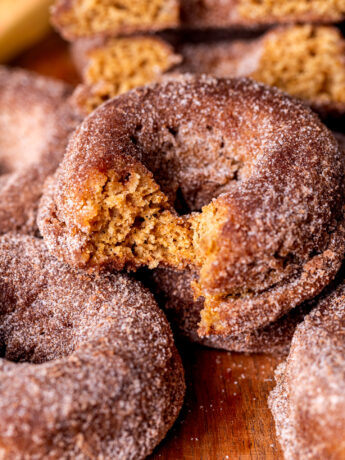 Bite missing from apple cider donuts.