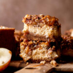 Stack of two caramel apple cheesecake bars.