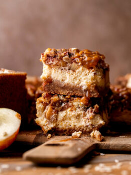 Stack of two caramel apple cheesecake bars.