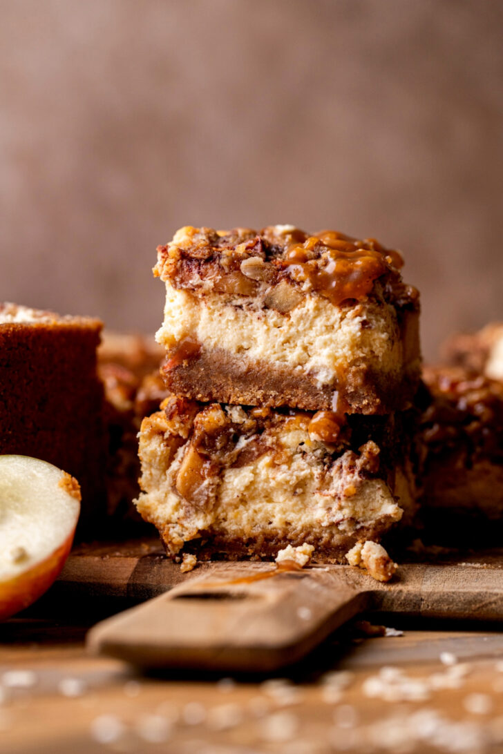 Stack of two caramel apple cheesecake bars.