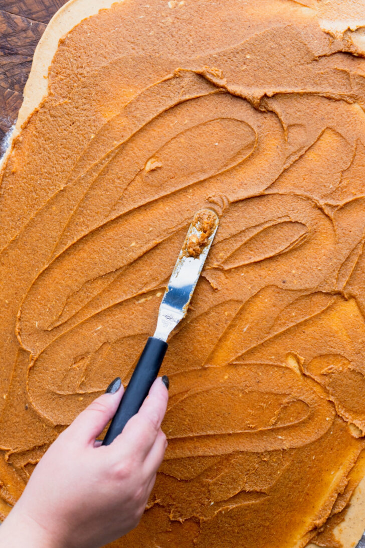 Spreading filling on top of dough.