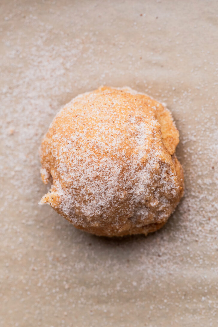 Cinnamon sugar on top of cookie dough ball.