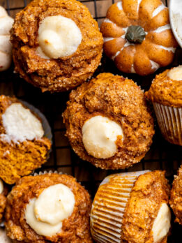 Close up top view of pumpkin cream cheese muffins.