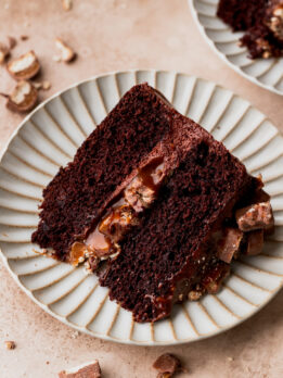 Slice of twix cake on a plate.