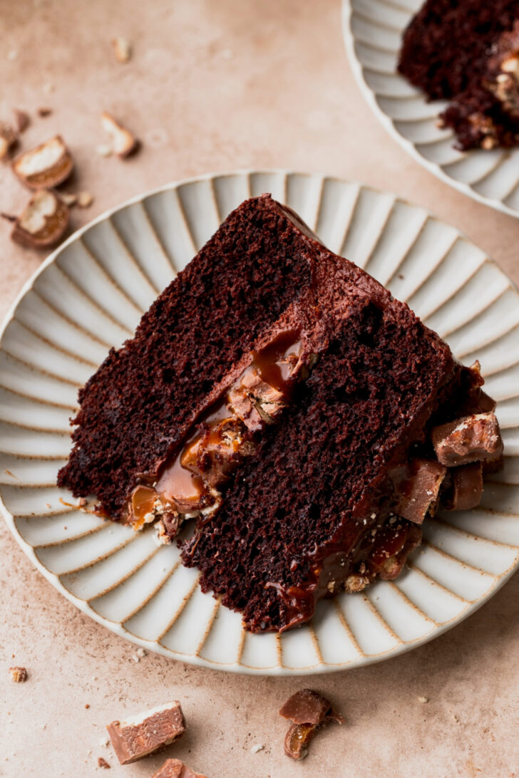 Slice of twix cake on a plate.