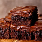 Stack of two chocolate caramel cake slices.