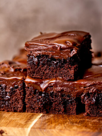 Stack of two chocolate caramel cake slices.