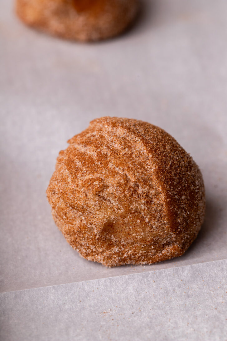 Cookie dough ball on parchment paper.