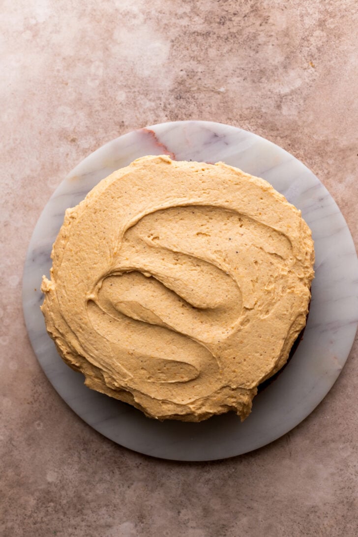 Pumpkin frosting on top of cake layer.