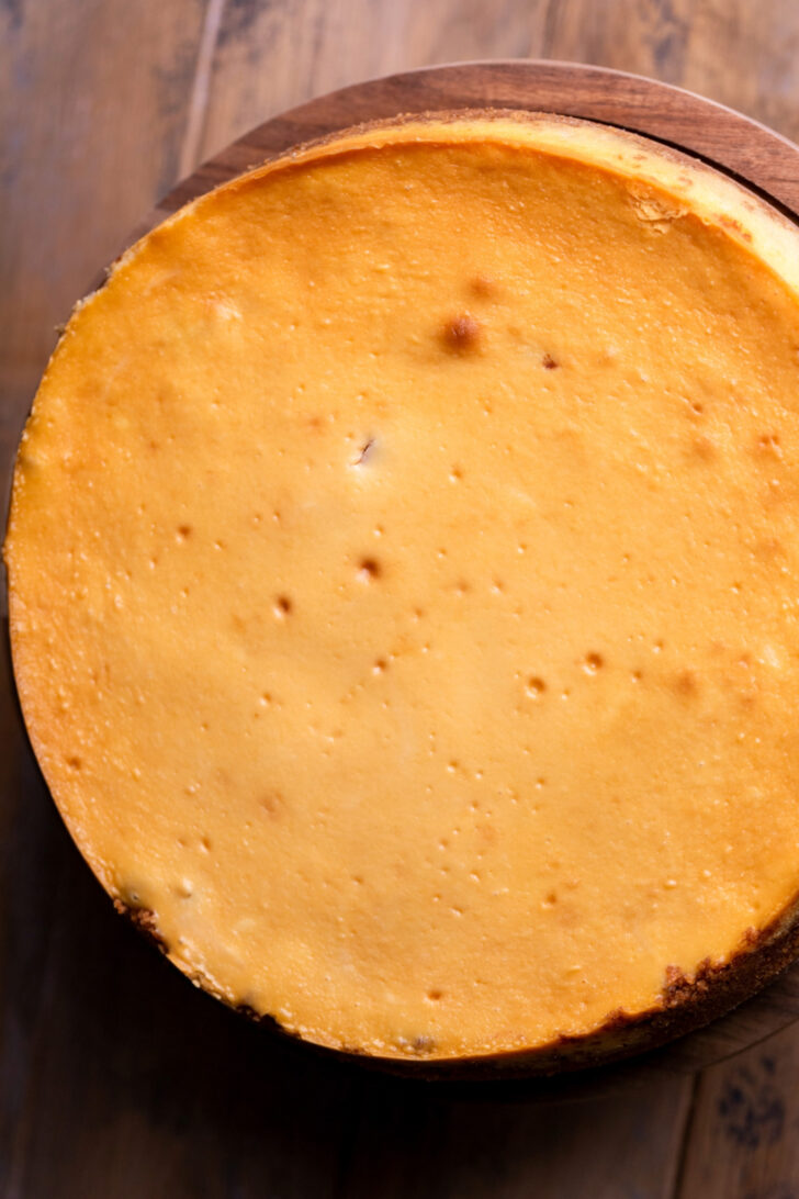 Baked cheesecake on a wood board.