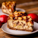 Side view of apple pie cheesecake on a plate.