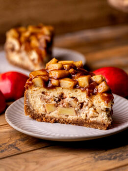 Side view of apple pie cheesecake on a plate.