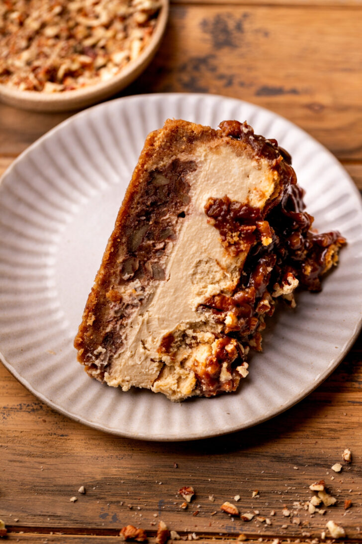 Cheesecake slice on its side on a plate.