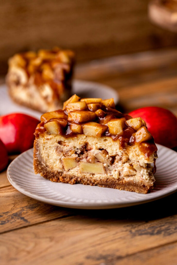 Side view of apple pie cheesecake on a plate.
