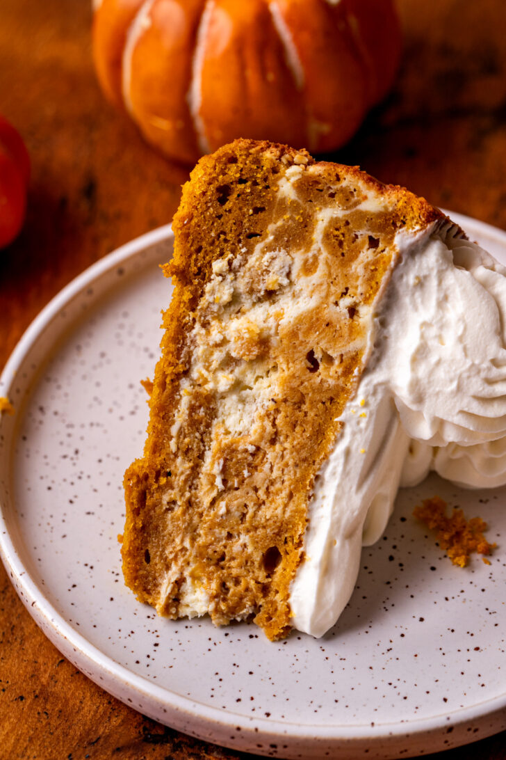 One slice of cake on its side on a plate.