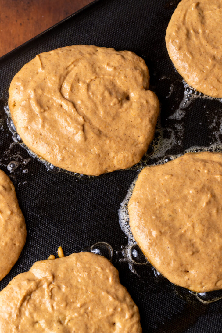 Pancake batter on a griddle.