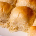 Side view of dinner rolls in a pan.