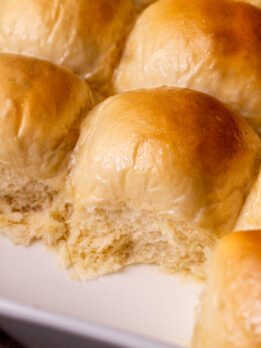 Side view of dinner rolls in a pan.