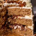 Taking a pecan pie cake slice out of the cake.