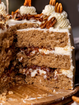 Taking a pecan pie cake slice out of the cake.