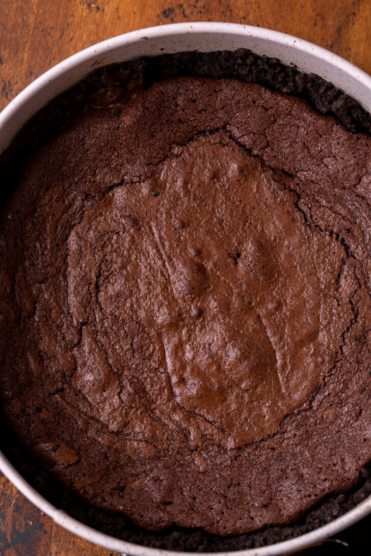 Baked brownie in the pan on top of the crust.