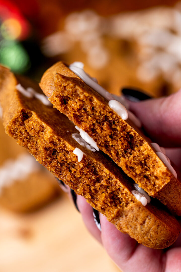 Holding one cookie split in half.