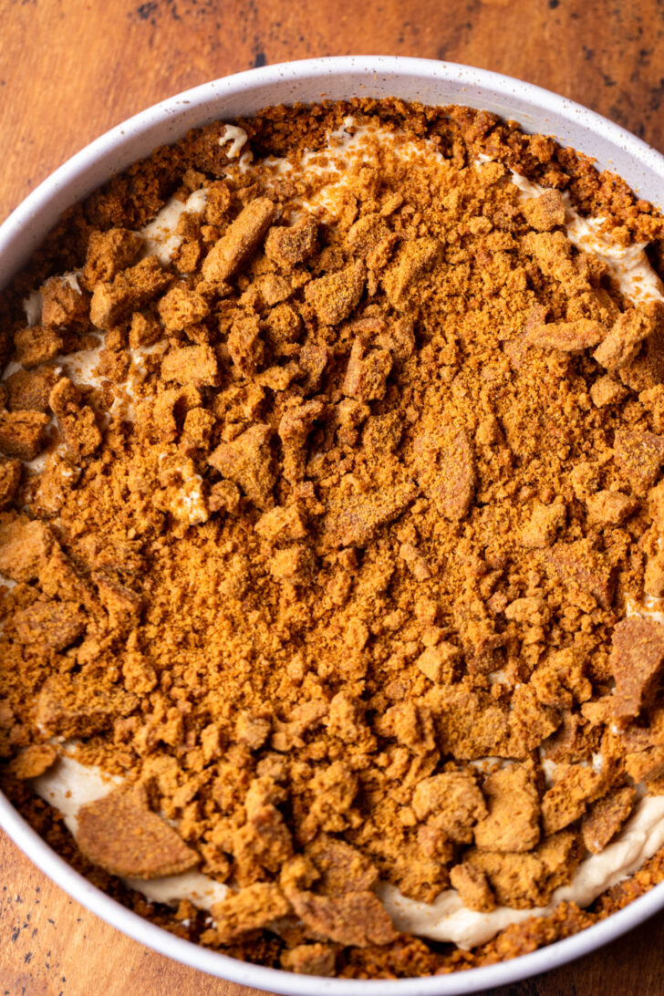 Gingersnap crumbs on top of cheesecake batter.
