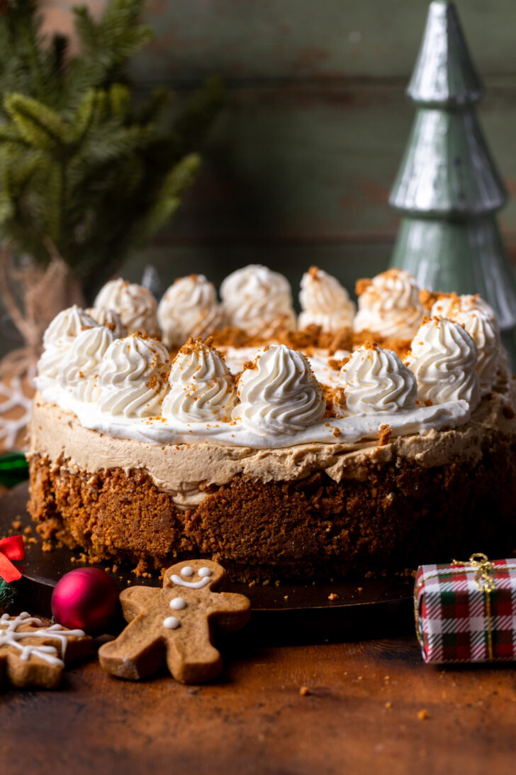 Decorated cheesecake on a wood board.