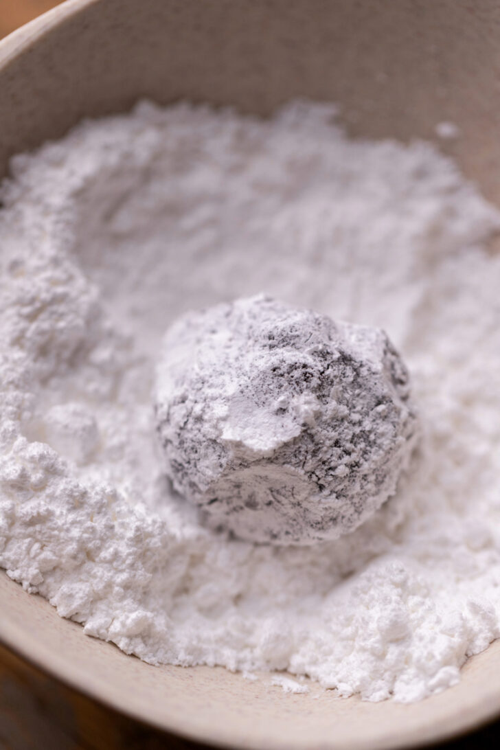 Cookie dough ball in a powdered sugar.
