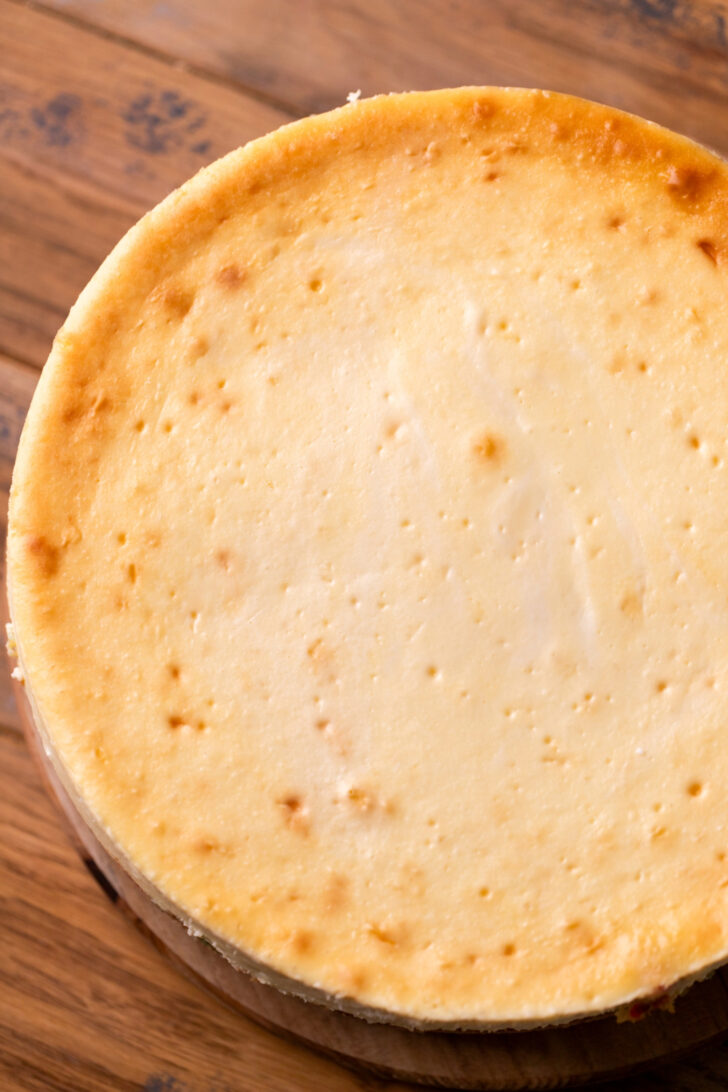 Baked cheesecake on a wood board.