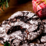 A bite missing from chocolate crinkle cookies.