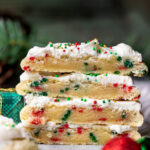 Stack of two Christmas sugar cookies split in half.