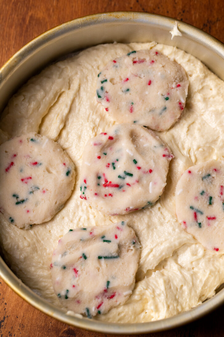 Cookie dough on top of cake batter in a pan.