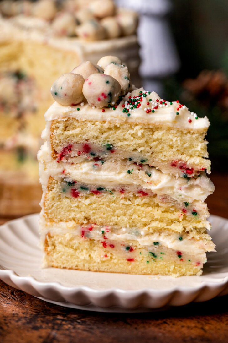 One piece of cake on a plate standing up.