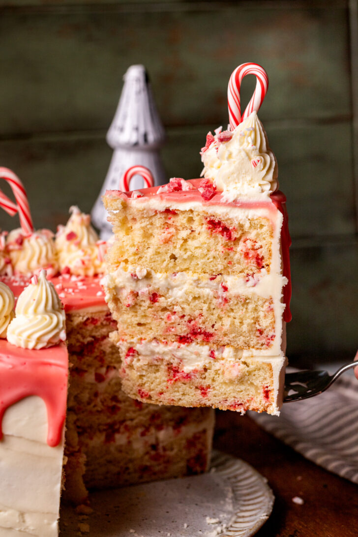 Pulling a cake slice out of the cake.