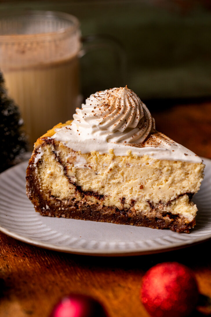 One slice of eggnog cheesecake on a plate.