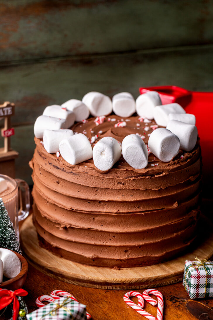 Decorated cake on top of wood board.