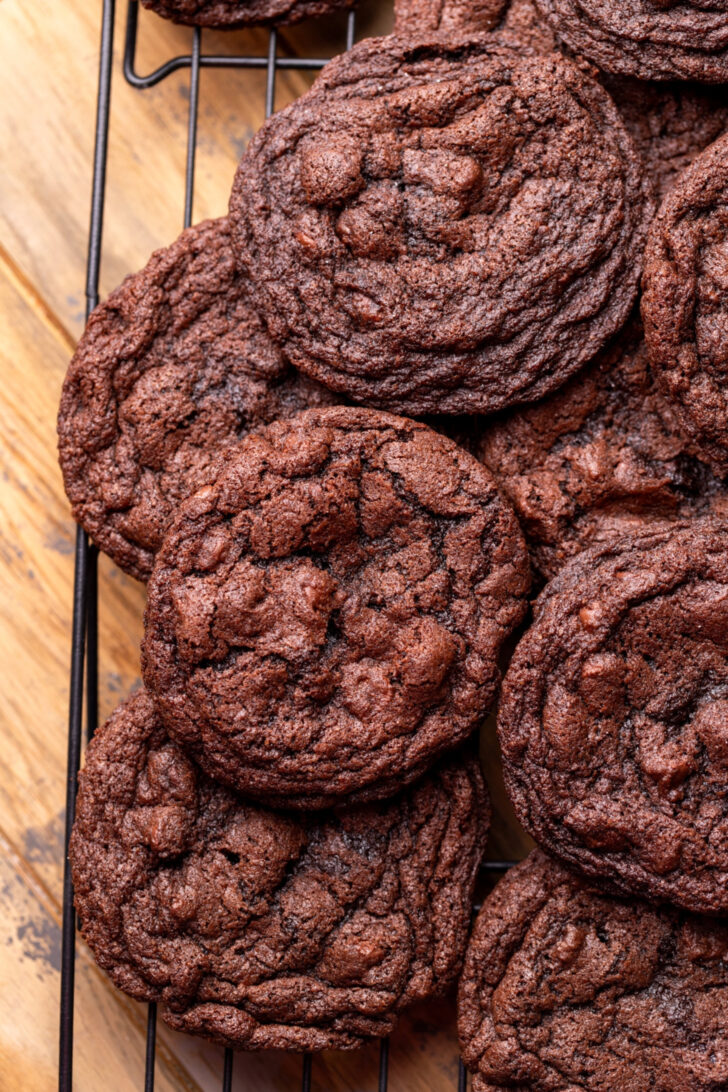 Baked chocolate cookies on a wire rack.