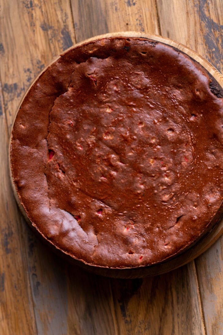Baked cheesecake on a wood board.