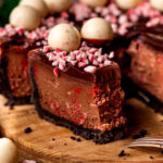 Bite missing from a slice of chocolate peppermint cheesecake.