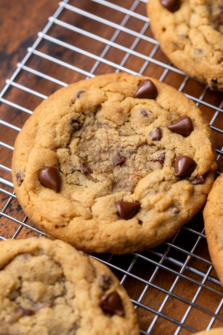 Cookie with a hole in the middle on a wire rack.