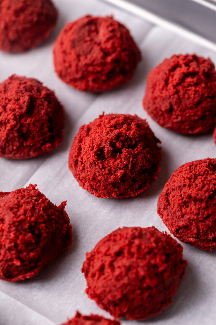 Cookie dough balls on a cookie sheet.