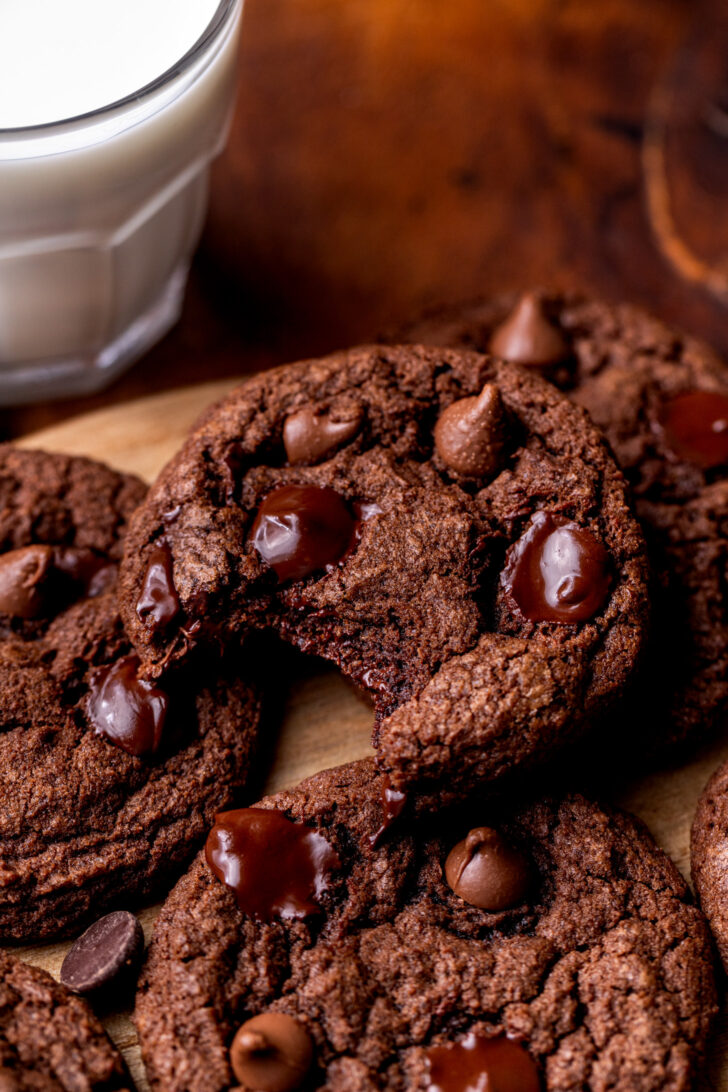 A bite missing from triple chocolate cookies.
