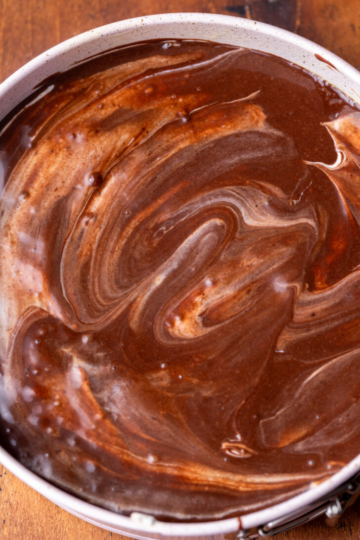 Chocolate cake batter spread on top.